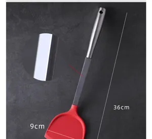 Silicone spatula detail view showing stainless steel handle and flexible red heat-resistant head.