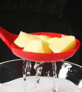 Detailed view of red silicone kitchen slotted spoon with drainage holes, perfect for cooking.