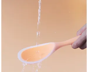 Detail view of anti-stick rice paddle, high temperature resistant spoon for electric cooker.