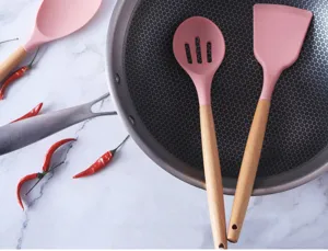 Pink silicone kitchen utensils set with wooden handle, durable nonstick spatula and spoon detail.