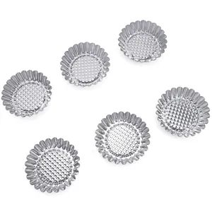 Stainless steel egg tart molds detail view, showing textured bottom and fluted edges for baking.