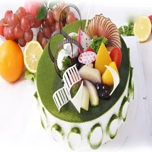 Délicieux gâteau rond aux fruits et au matcha décoré de fruits frais en chocolat.