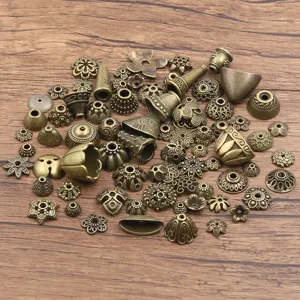 Detail view of antique bronze alloy bead caps, floral spacer findings for DIY jewelry making.
