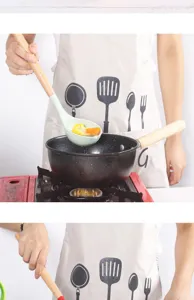 Silicone soup ladle with natural wooden handle shown in kitchen cooking detail view closeup.