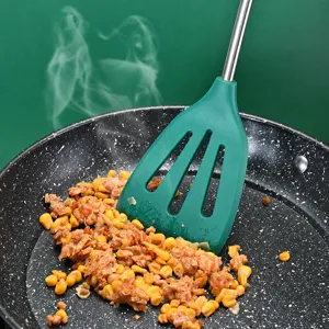 Green silicone slotted spatula with stainless steel handle for household kitchen cooking and daily frying.