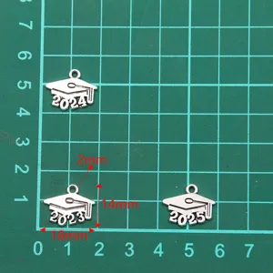 Detail view of silver metal graduation cap charms with 2023 2024 2025 year numbers, 14x18mm