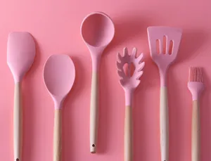 Silicone kitchen utensils set detail view, pink heat resistant spatula and soup ladle tools