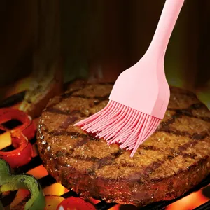 Pink silicone basting brush for BBQ grilling and baking, seamless design easy to clean.