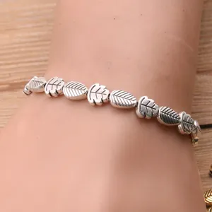 Detail view of antique silver alloy double-sided leaf beads bracelet DIY connector.