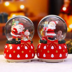 Weihnachtsschneekugel Spieluhr mit Weihnachtsmann Schneemann Lebkuchenmann und Schleife.