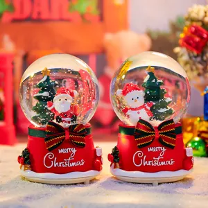 Close-up of Christmas snow globe with cute Santa Claus, glowing lights and rotating snowflakes.