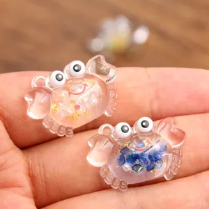 Detailed shot of clear resin crab pendants with glitter, ideal for DIY necklace making.