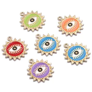 Close-up details of colorful enamel sun evil eye alloy pendants, jewelry making accessories.