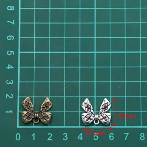 Retro metal bow charm pendant detail, 19x21mm size, DIY jewelry accessory and phone strap.