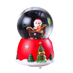 Christmas snow globe with Santa Claus in sleigh, red base and trees, holiday home decor gift.
