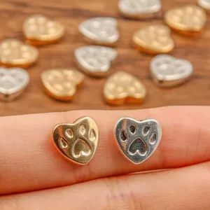 Close-up detail of double-sided alloy heart paw print charm bead, ideal for DIY jewelry making.