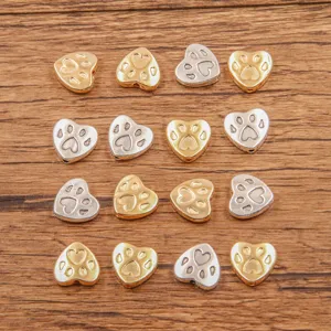 Detail view of alloy heart paw print beads, dual-color DIY jewelry connectors for bracelets.