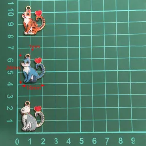 Detail shot of cute cat shaped alloy enamel charms in multi colors, showing size.