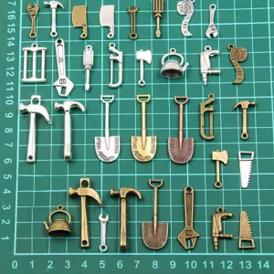 Detailed view of assorted DIY metal tool charms, miniature hardware pendants for crafts.