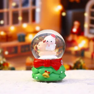 Christmas mini snow globe with glowing light, cute snowman and deer figure, festive holiday decor.
