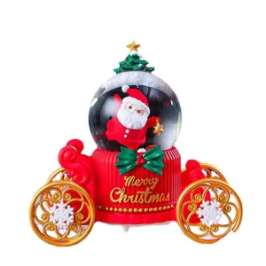 Christmas Santa Claus carriage snow globe with glowing lights and festive holiday decor.