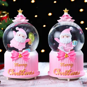 Pink Christmas Santa snow globe detail shot, cute resin desktop decoration gift for holidays.