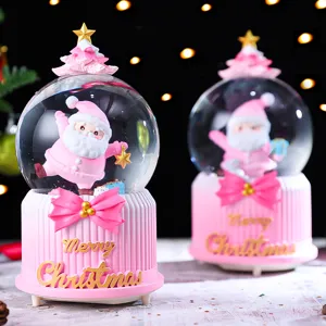 Cute pink Christmas snow globe with Santa Claus figure, perfect holiday desktop decoration gift.