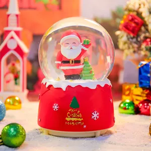 Detailopname van kerstsneeuwbol met kerstman, oplichtende verlichting en decoratieve voet.