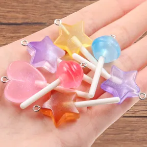 Close-up of colorful resin candy charms, star and heart pendants for DIY bracelets and bags.