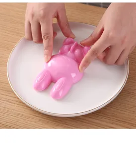 Hand operating detail view of pink rabbit rice ball mold for creative kitchen bento