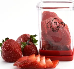 Clear plastic strawberry slicer container detail view with fresh sliced fruits.