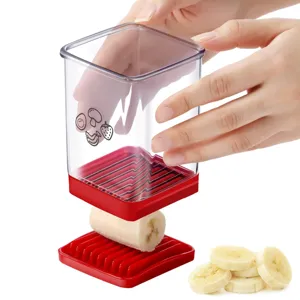 Banana slicer detail view showing transparent container and stainless steel cutting blades for fruit.
