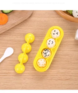 Nahaufnahme des gelben Plastik-4-Kugel-Reisform-Sets mit süßen Reisbällchen darin.