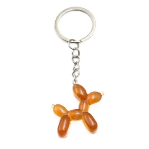 Close-up detail of a cute brown glitter resin balloon dog keychain with metal ring.