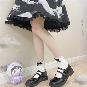 Detail view of Japanese JK style solid color mid-tube socks with cute ruffle and bow.