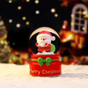 Christmas snow globe decoration with cute Santa Claus figure and red base for holiday gift.