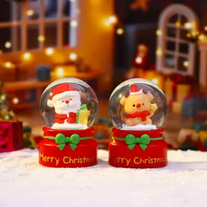 Detailed shot of cute Christmas snow globes with Santa and deer, glowing holiday decor.