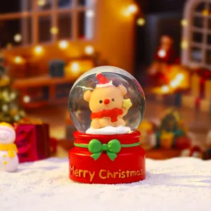 Detailed shot of a cute Christmas snow globe featuring a bear in a Santa hat, ideal for gifts.
