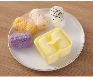 Cylindrical two-compartment rice ball mold detail showing practical kitchen DIY sushi tool.