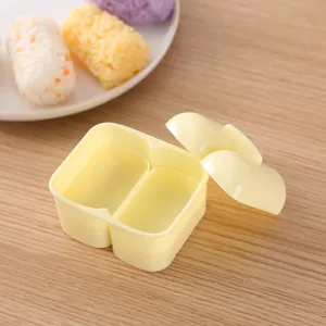 DIY double compartment rice ball mold for sushi making, cute yellow plastic kitchen tool.