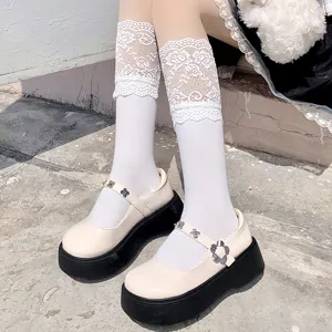 Close-up detail shot of Japanese style white lace trim knee high socks for daily wear.