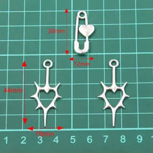 Silver alloy DIY jewelry charms, hollow heart safety pin and star pendants for crafting.