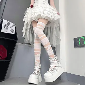 Detail shot of white bandage over-the-knee socks paired with platform shoes, JK style.