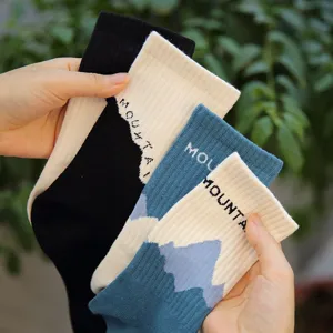 Detailed view of trendy Japanese streetwear long socks featuring unique mountain patterns.
