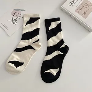 Asymmetric black and white zebra print long socks for women and men, trendy street style socks.