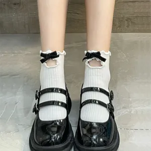Cute Japanese JK style white short socks featuring black velvet bows and lettuce edge trim.