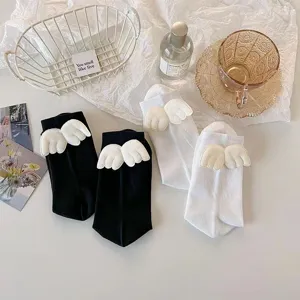 Cute Japanese Lolita JK mid-calf socks with 3D angel wings design, black and white pair.