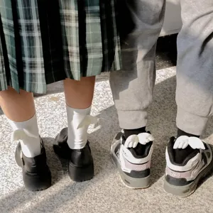 Cute white wing mid-calf socks for women, sweet JK style fashion accessory detail shot.