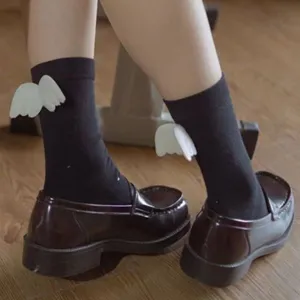 Cute Japanese style black mid-tube JK socks featuring white 3D angel wings for sweet girls.