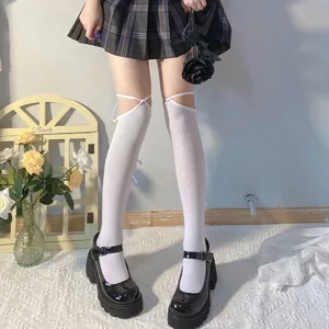 Detail view of women white over-the-knee socks featuring cute cross straps for JK daily wear.